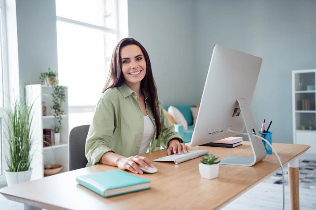 Portrait of pretty cheerful successful lady sit chair coworking networking pc display mouse keyboard desk office inside